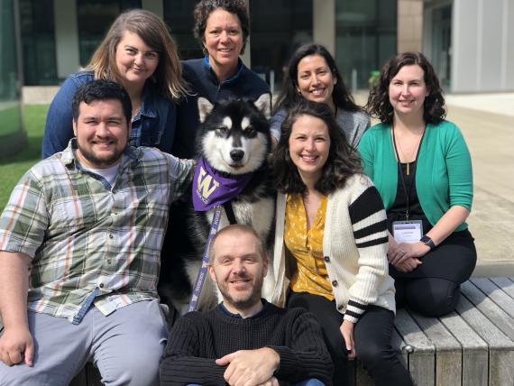 People posing for a photo with UW mascot dog dubs